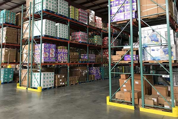 Warehouse racking stocked with palletised retail goods