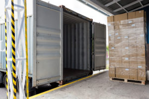 Forklift with carton boxes loading the truck
