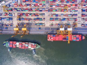 container,container ship in import export and business logistic.By crane , Trade Port , Shipping.Tugboat assisting cargo to harbor.Aerial view.Water transport.International.Shell Marine.
