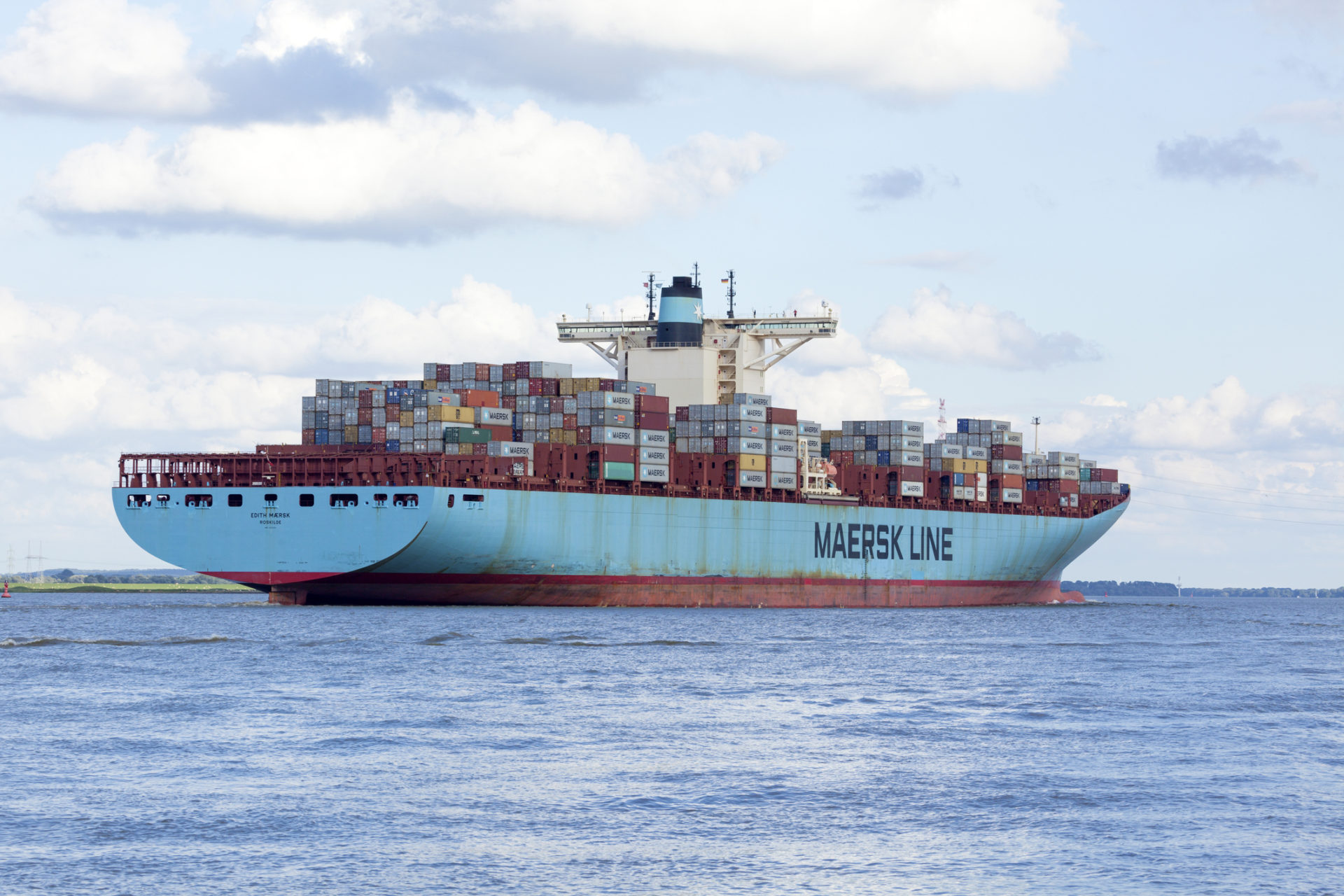 Stade, Germany - August 21, 2016: EDITH MAERSK, one of the world's largest cargo ships, operated by Danish shipping company Maersk Line, near Hamburg on Elbe river.