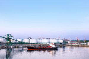 Dry cargo vessel and bunkers at Marina in Ventspils at sunset. Ventspils a city in the Courland region of Latvia. Latvia is one of the Baltic countries